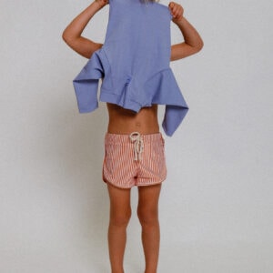A little girl wearing the Playtime Collection - Nella Rash Shirt - Mandarin shorts.