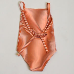 Sentence with the replacement: A mandarine stripe one piece swimsuit.