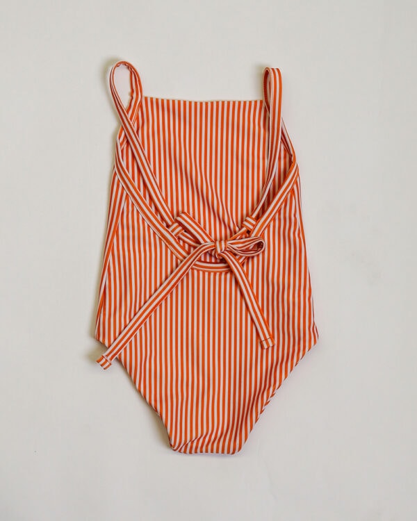Sentence with the replacement: A mandarine stripe one piece swimsuit.
