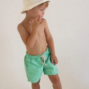 A young boy wearing Sorbet Summer - Sea Shorts and a white hat.