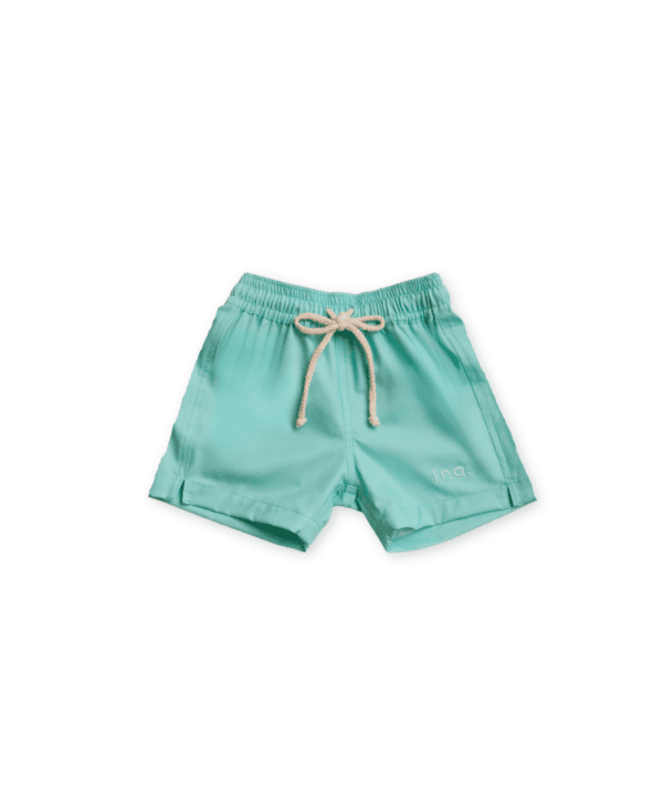 A pair of Sea Shorts - Mint with a string.