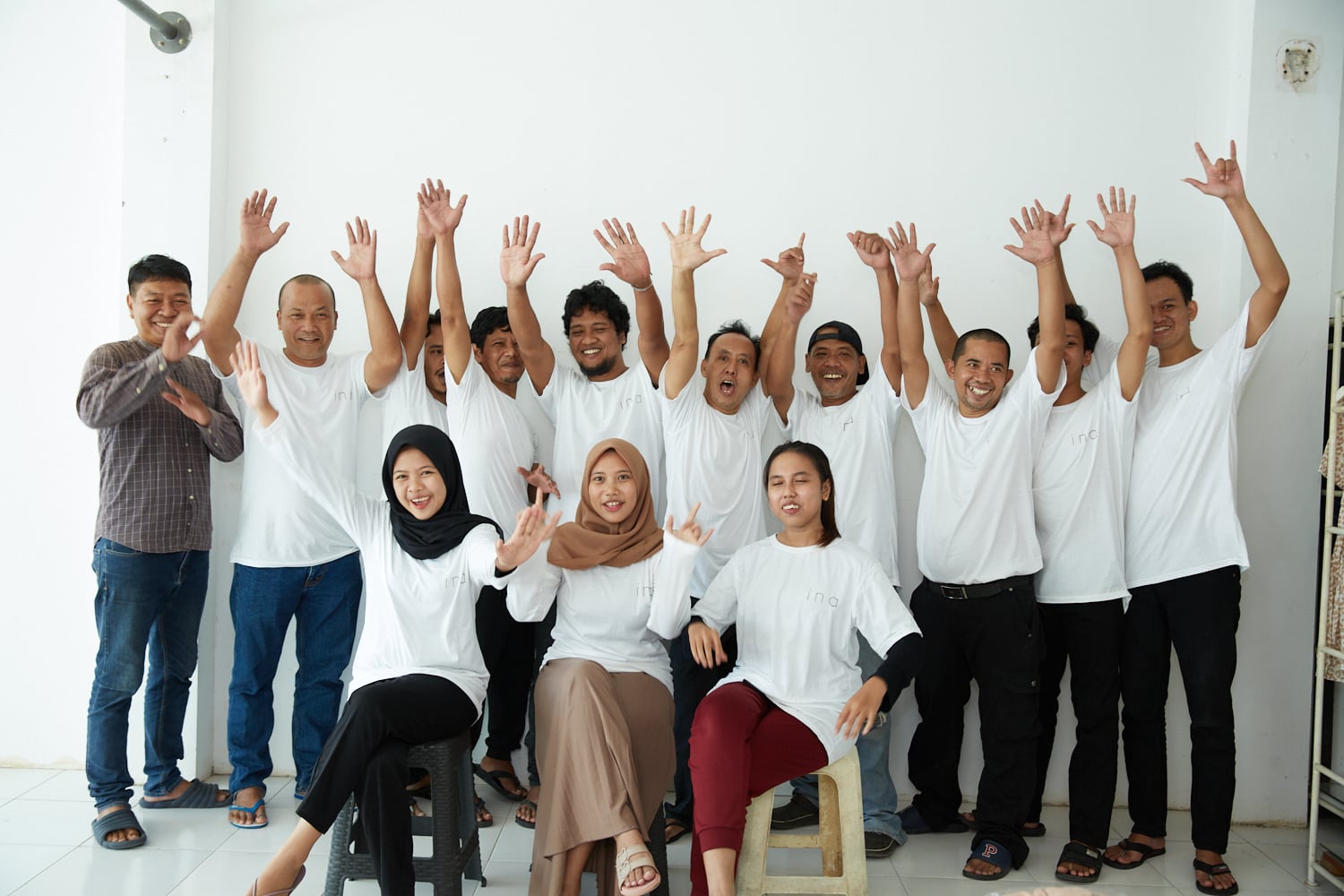 A group of people in white shirts posing for a photo.