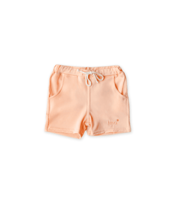A pair of Amias Trunks - Peach Blossom with a drawstring on a white background.