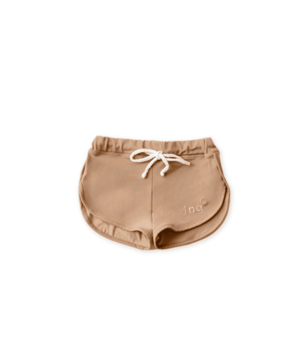 A pair of Mesa Trunks - Warm Pecan with drawstrings on a white background.