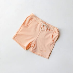 Pair of Amias Trunks - Peach Blossom with drawstring on a white background.