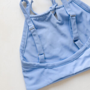 Luna Bikini - Powder Sky sports bra with adjustable straps on a white background.